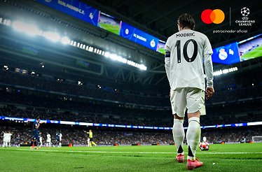 A footballer standing at the corner of the playground ready to kick the ball during UEFA Champions League game.