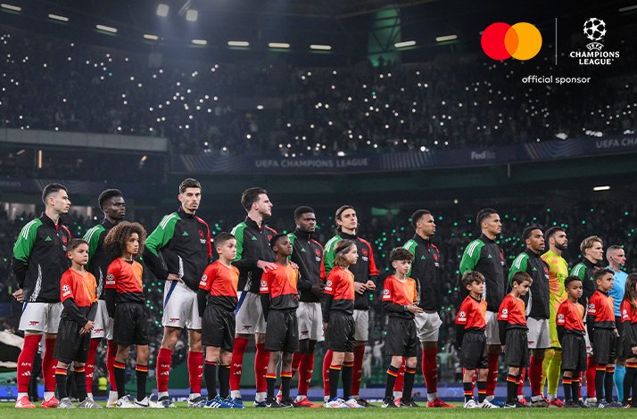 Players of Arsenal FC lining up on the field before an UEFA Champions League match