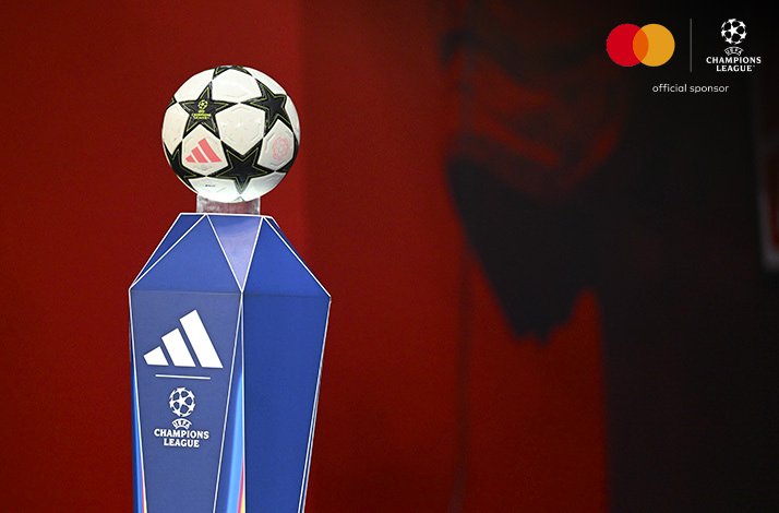 Adidas branded official match ball on a pedestal, Mastercard and UEFA Champions League 'official sponsor' logos in the upper-right corner.