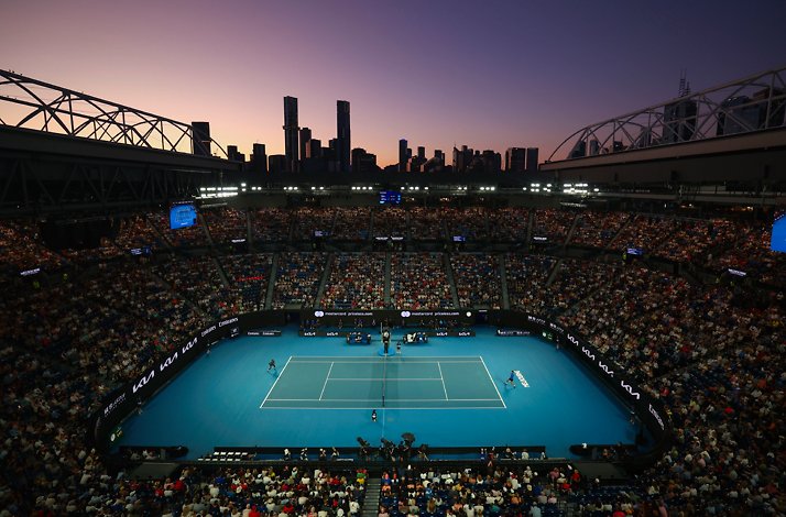 Aerial view of a night time live tennis play at Melbourne Park.