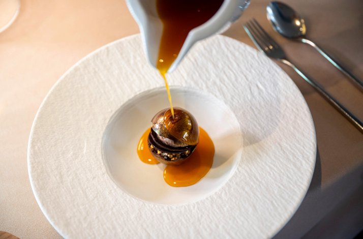 One of the iconic dishes with sauce being poured on from above by Chef Daniel Canzian.