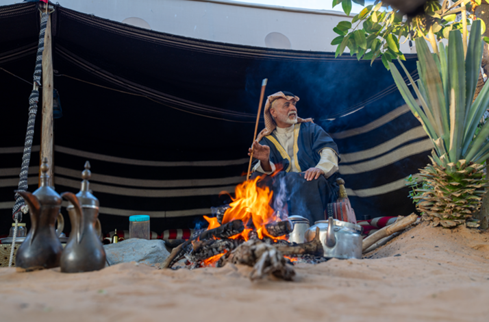 Traditional coffee brewing over an open fire in a Bedouin camp, showcasing Emirati hospitality