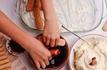 A child making tiramisu at a chef-led masterclass at Eataly Flatiron.