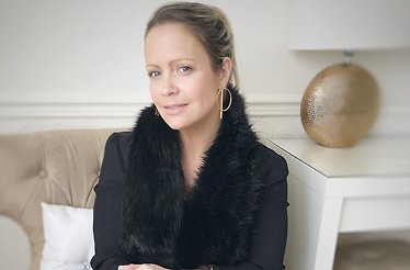 Portrait of fashion stylist Sharon Warten on a sofa